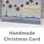 One Horse Open Sleigh Designer Series Paper with copper snowflakes and a sending warmth sentiment.