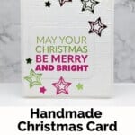 Stampin' Up! Joy To You Christmas Card featuring a May Your Christmas Be Merry & Bright sentiment in green and red with die-cut stars in the same color.