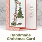 Orange and green Christmas card featuring a giraffee with the sentiment "May your season be one that's festive and fun."