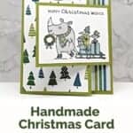 Christmas card in greens and blues featuring a rhino pulling a sled with birds and presents and sentiment "Happy Christmas Wishes."
