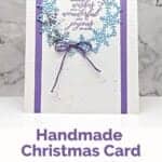 Christmas card in blues and purples featuring a wreath of snowflakes and a sentiment "sending wishes for a wondering and joyous season."