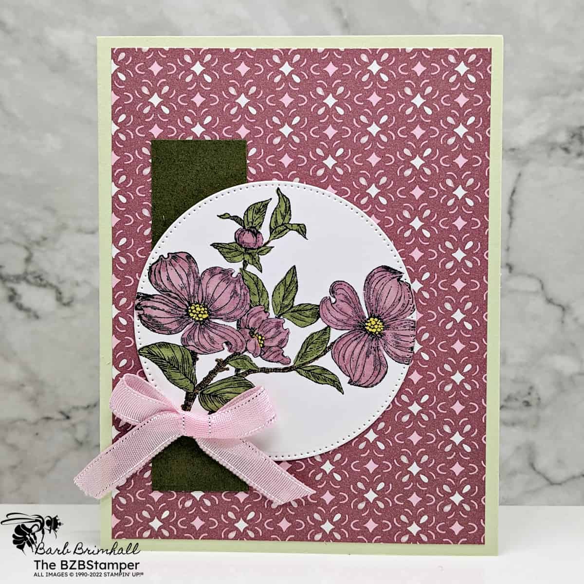 Detailed Dogwood Sale-A-Bration Stamp Set 1 Detailed Dogwood Sale-A-Bration Stamp Set in mauve and light green with dogwood flowers on a circle and some pretty patterned paper. No sentiment on card.