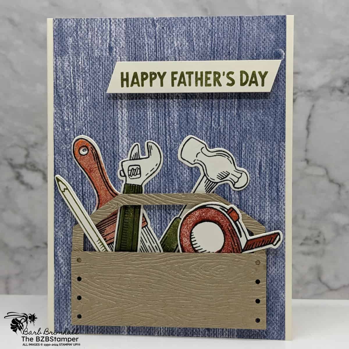 Trusty Tools Bundle 1 Trusty Tools Bundle card featuring a Happy Father's Day sentiment, with a tool box filled with stamped tools. Colors of blue, rust, green and kraft.