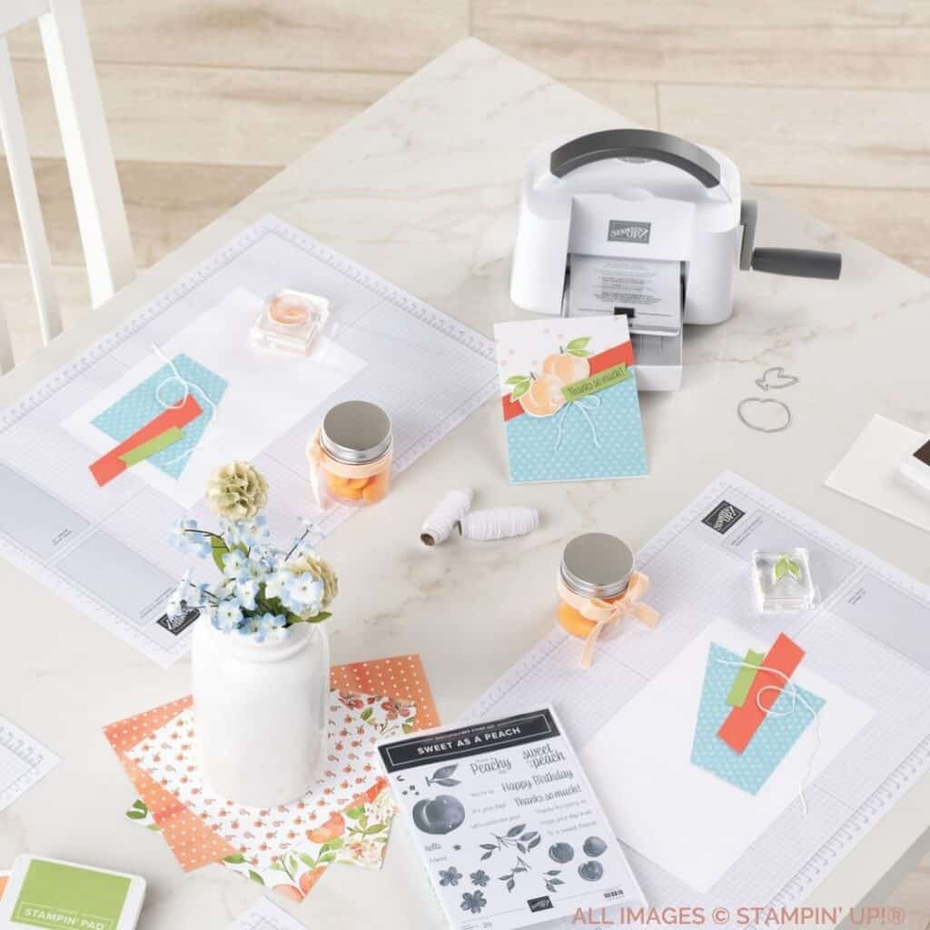 15 Reasons Why It's Important To Craft 2 15 Reasons Why It's Important To Craft with a picture of a stamp set, some ribbon, papercrafting supplies, a Cut & Emboss Machine at a table in blues, greens and corals.