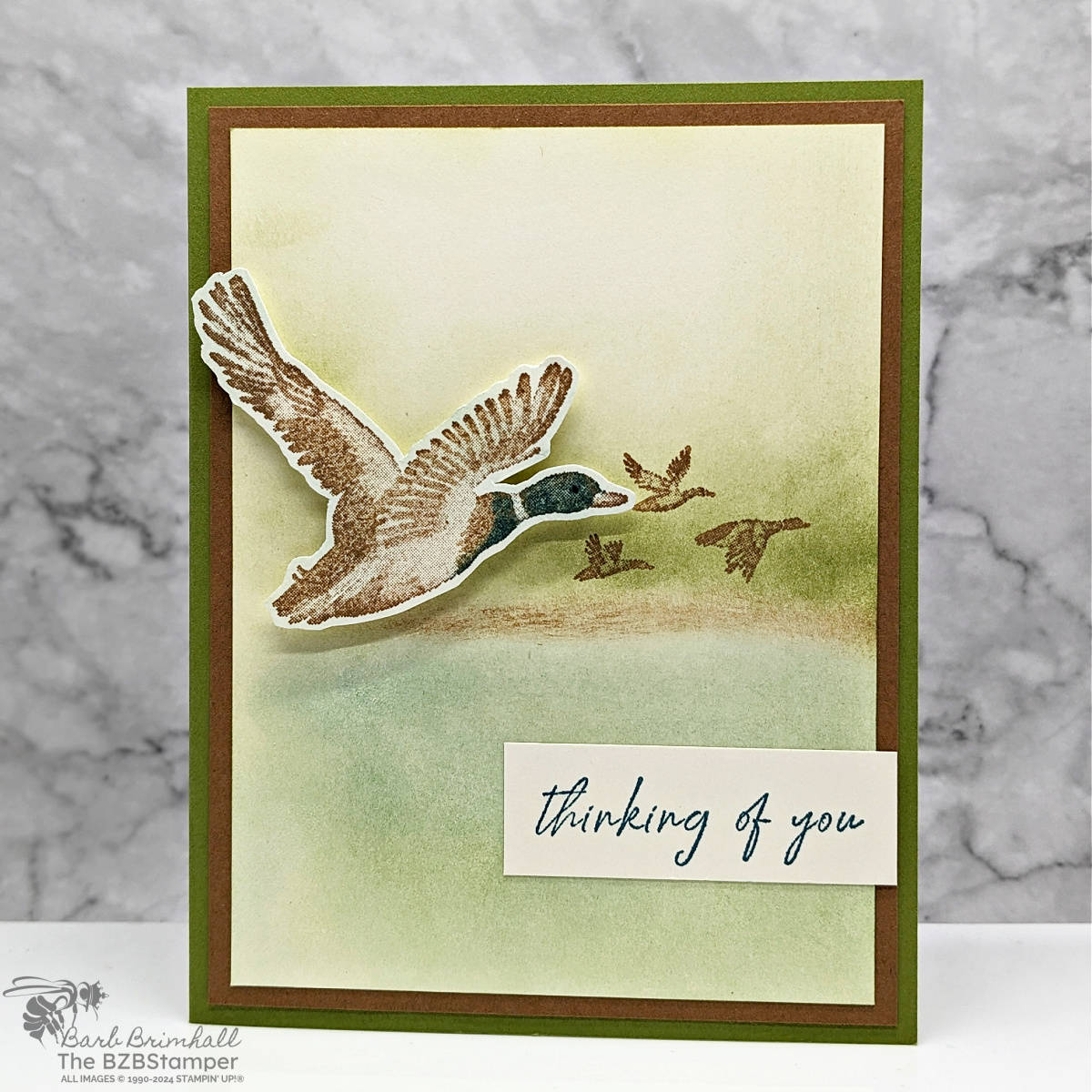 Feathered Flight Thinking of You Card 1 Feathered Flight Thinking of You Card in browns and greens, featuring a duck in flight., with a sponged background.