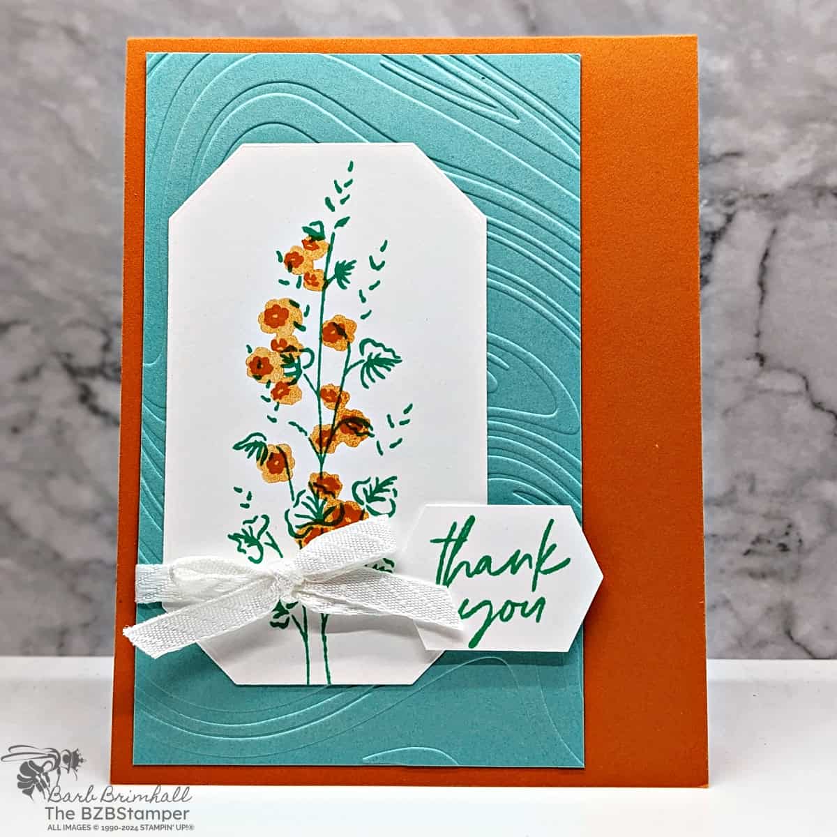 Flowers of Beauty Thank You Card 1 Flowers of Beauty Thank You Card in aqua and orange with a single flower stem, an embossed background and a thank you sentiment.