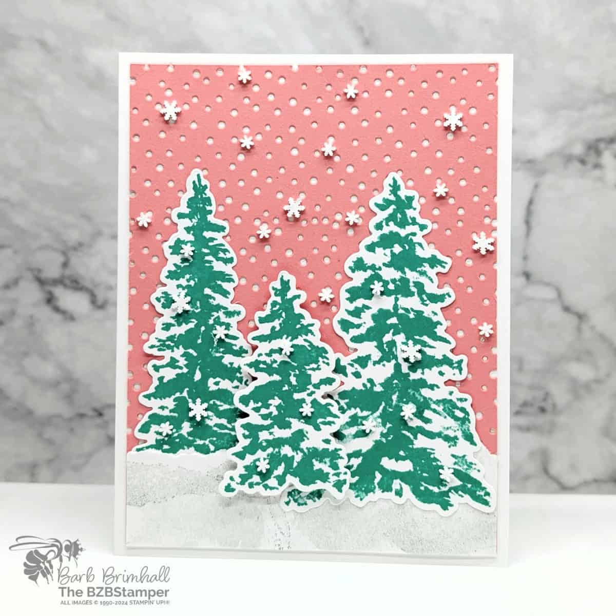 Bright Twist on Winter Peaceful Evergreens Card 1 Bright Twist on Winter Peaceful Evergreens Card in bright coral and green. Dotted die-cut background with 3 fir trees of different sizes and lots of snowflake embellishments. No sentiment on this card.
