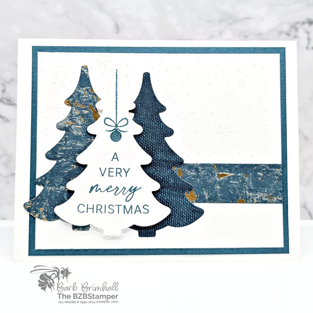 Very Merry Christmas Card with Decorative Trees 1 Very Merry Christmas Card with Decorative Trees Bundle featuring 3 die-cut trees in different shades of blue and a snowflake embossed background.