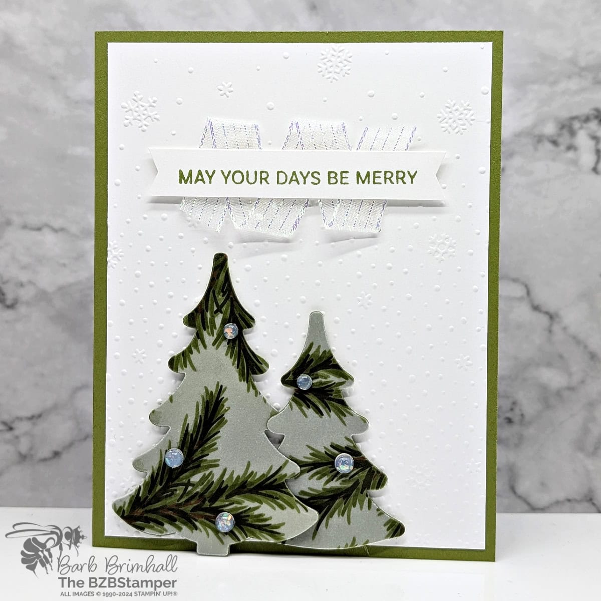 Be Merry with the Decorative Trees Bundle 1 May Your Days Be Merry with the Decorative Trees Bundle featuring 2 Christmas Tree die-cuts, a snow background, and pretty ribbon. In greens and white.
