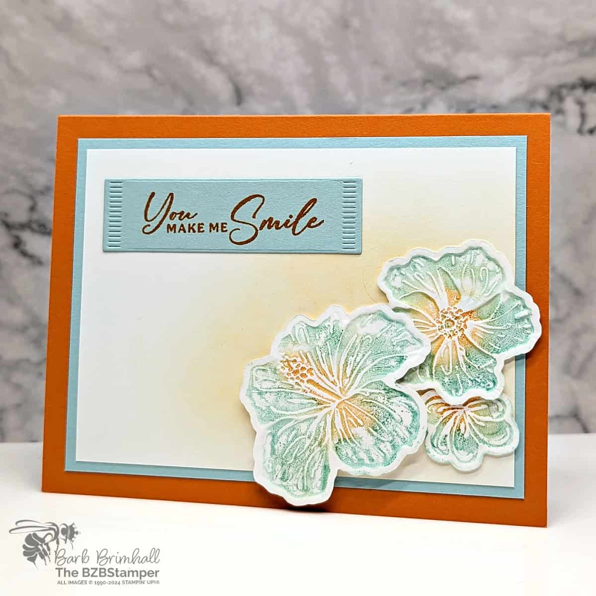 Happy Hibiscus All-Occasion Card 1 Happy Hibiscus All-Occasion Card in blues and oranges featuring 3 die-cut hibiscus flowers and a sentiment "you make me smile"