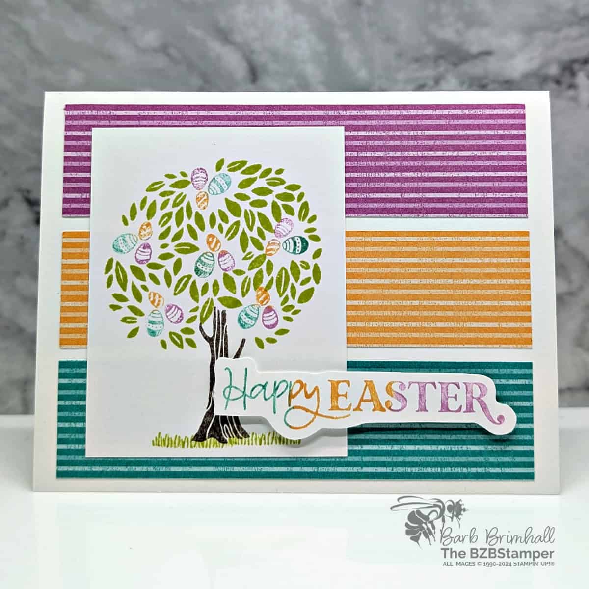 Happy Easter Card Using the Pick A Season Stamp Set 1 Happy Easter Card Using the Pick A Season Stamp Set in purple, blue and peach, featuring a tree hiding Easter Eggs.
