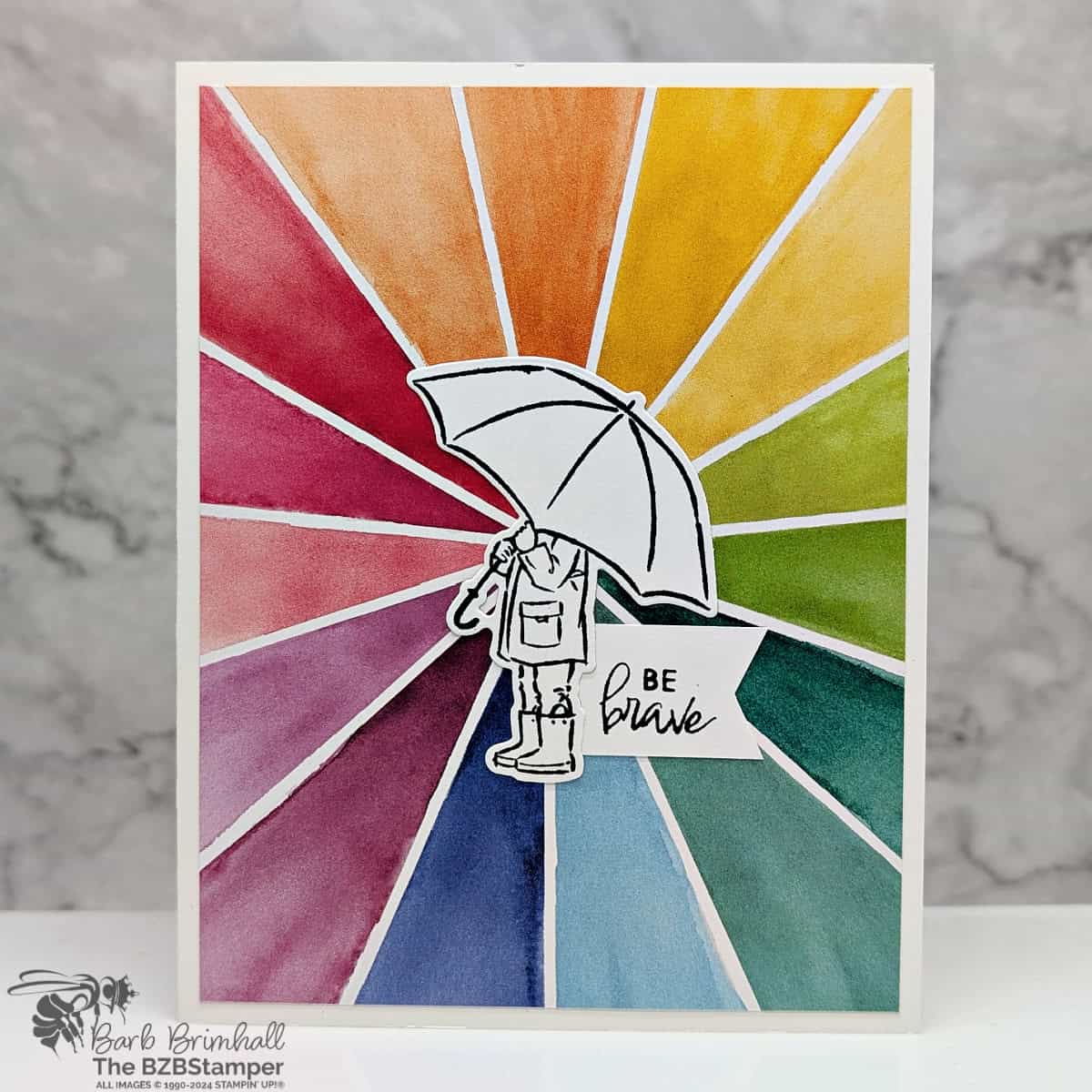 Stampin' Up! Umbrella Days Bundle Encouragement Card 1 Stampin' Up! Umbrella Days Bundle Encouragement Card featuring a bright sunburst of patterned paper color, a girl holding an umbrella and a "be brave" sentiment.