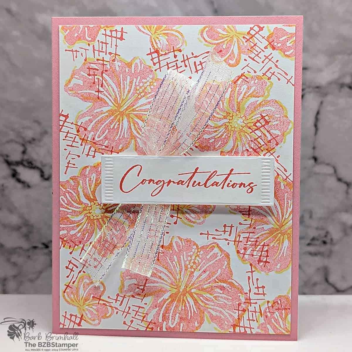 Congratulations Card With the Happy Hibiscus Bundle 1 Congratulations Card With the Happy Hibiscus Bundle in soft pink and yellow flowers with a "congratulations" sentiment and some white sparkly ribbon.
