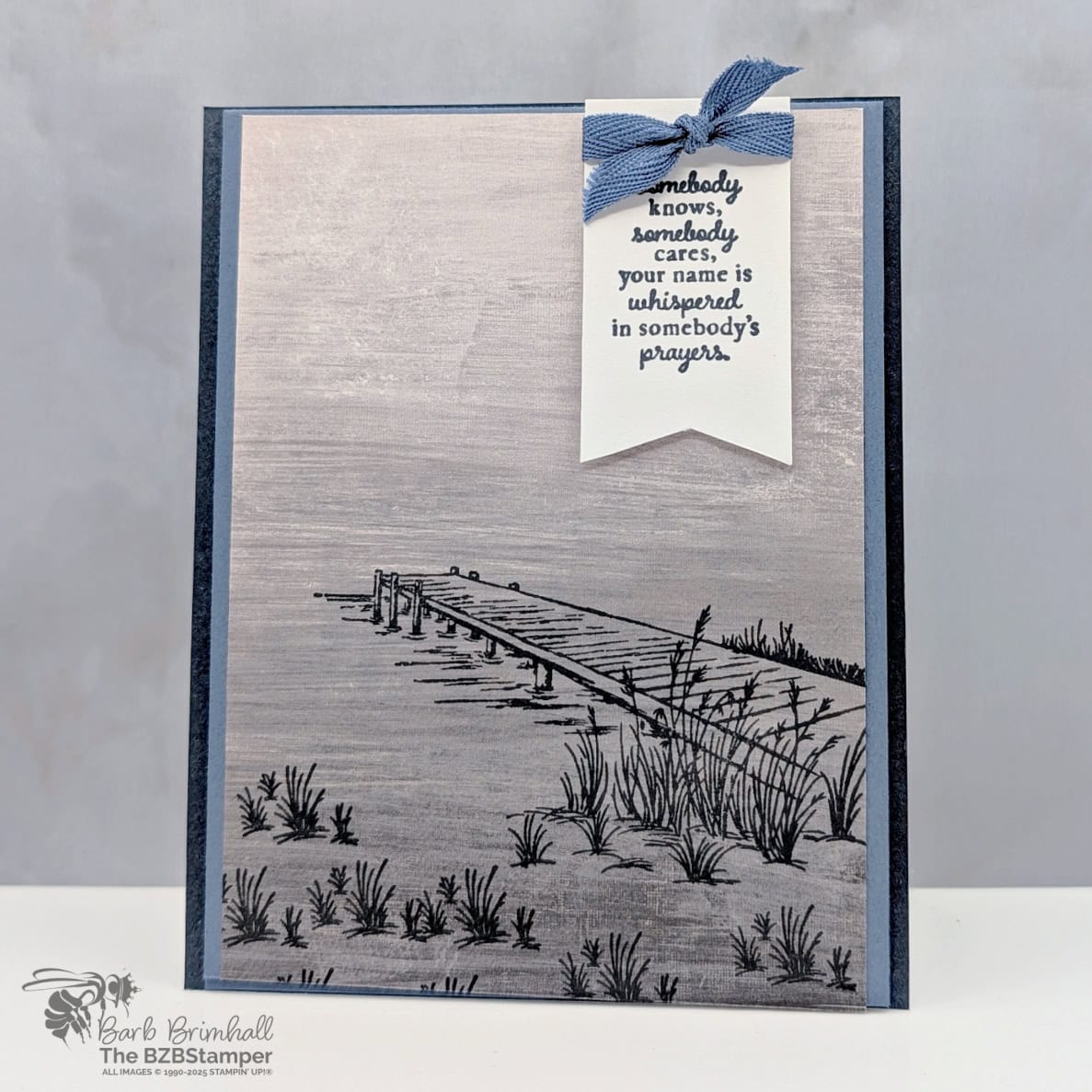 Coffee and a Card Project with the Peaceful Pier Stamp Set 1 Coffee and a Card Project with Peaceful Pier Stamp Set a pier image with grass in blues and grays and a "somebody know, somebody cares, your name is whispered in somebody's prayers" sentiment.