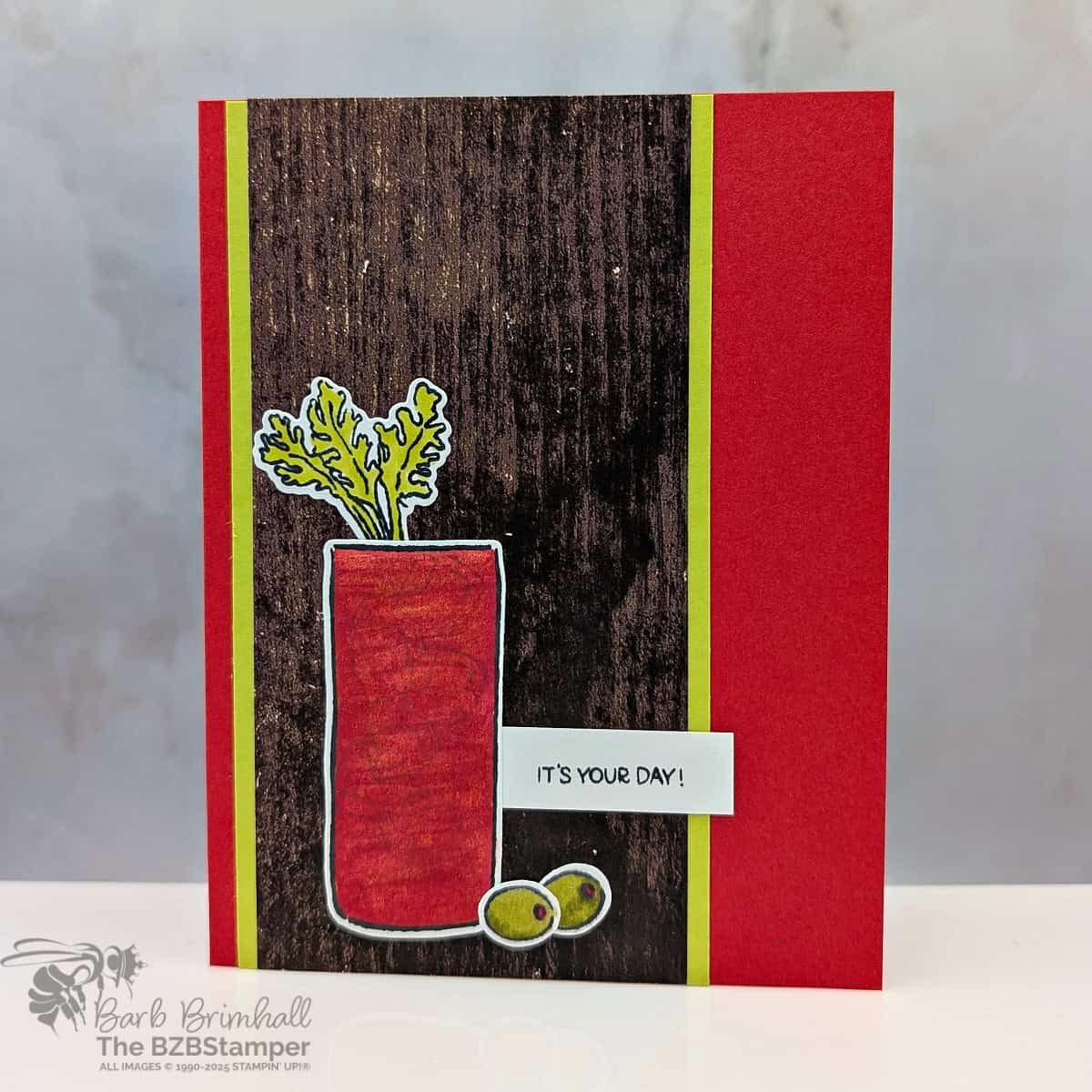 Sip Sip Hooray with the Cheers and Sips Bundle in reds, greens and brown woodgrain paper.  Sentiment is "it's your day" featuring a bloody mary drink with 2 olives.