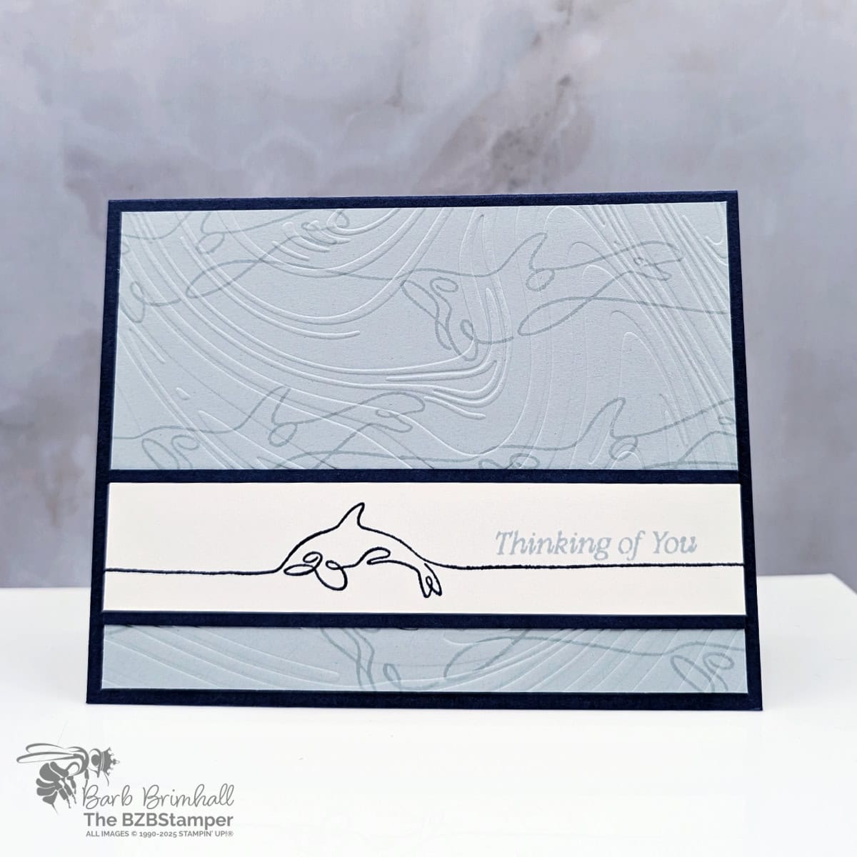 Clean and Modern Dolphin Card for Any Occasion 1 Clean and Modern Dolphin Card for Any Occasion in shades of blue, featuring an embossed background and a whimsical dolphin image with a "thinking of you" sentiment.