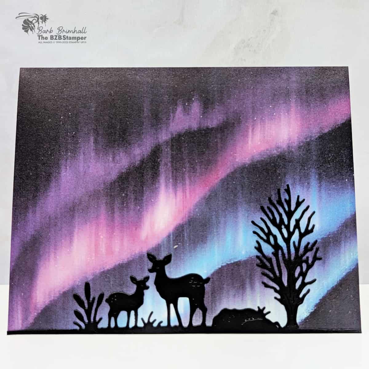 Magical Scenic Card using the Autumn Trees Dies with deer and tree silhouettes cut from Basic Black cardstock, layered over Lights of Aurora Designer Series Paper for a northern lights background in purples and blues.