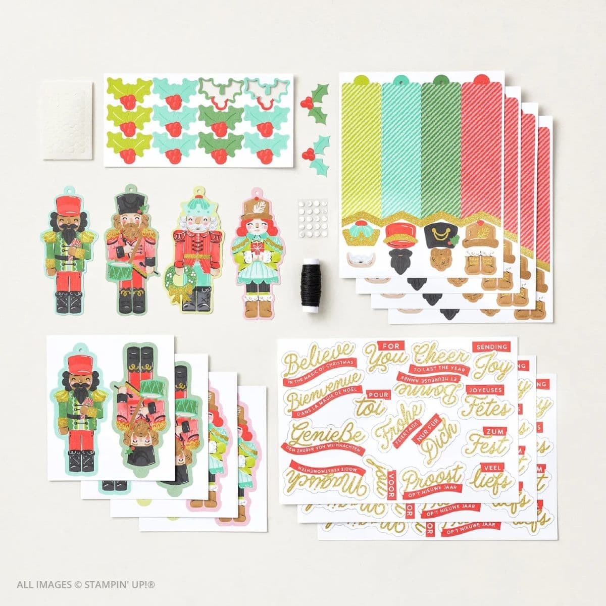 Easy Christmas Tags with the Nutcracker Tags Kit 1 Easy Christmas Tags with the Nutcracker Tags Kit , including colorful nutcracker die-cuts, striped tag bases, gold-foiled sentiment sheets in multiple languages, holly leaf embellishments, baker’s twine, adhesive dots, and assembly instructions—all arranged neatly on a white background.