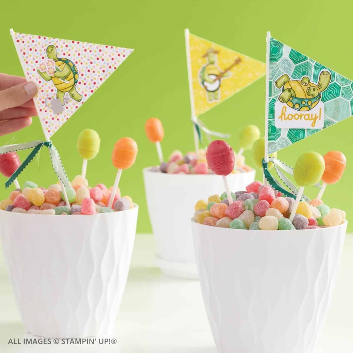 Building Relationships Through Cardmaking 4 Building Relationships Through Cardmaking. Bright handmade party decorations featuring cheerful turtle flags on sticks set in cups of colorful candies. A fun, creative use of stamping supplies for birthday or celebration décor.